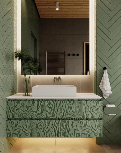 Интерьер ванной комнаты в зеленом цвете.